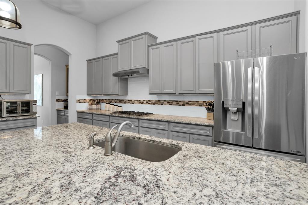 Huge Island Kitchen with Bosch Appliances, Butlers Pantry, Walk-in Pantry, Granite Surfaces and Tile Backsplash.
