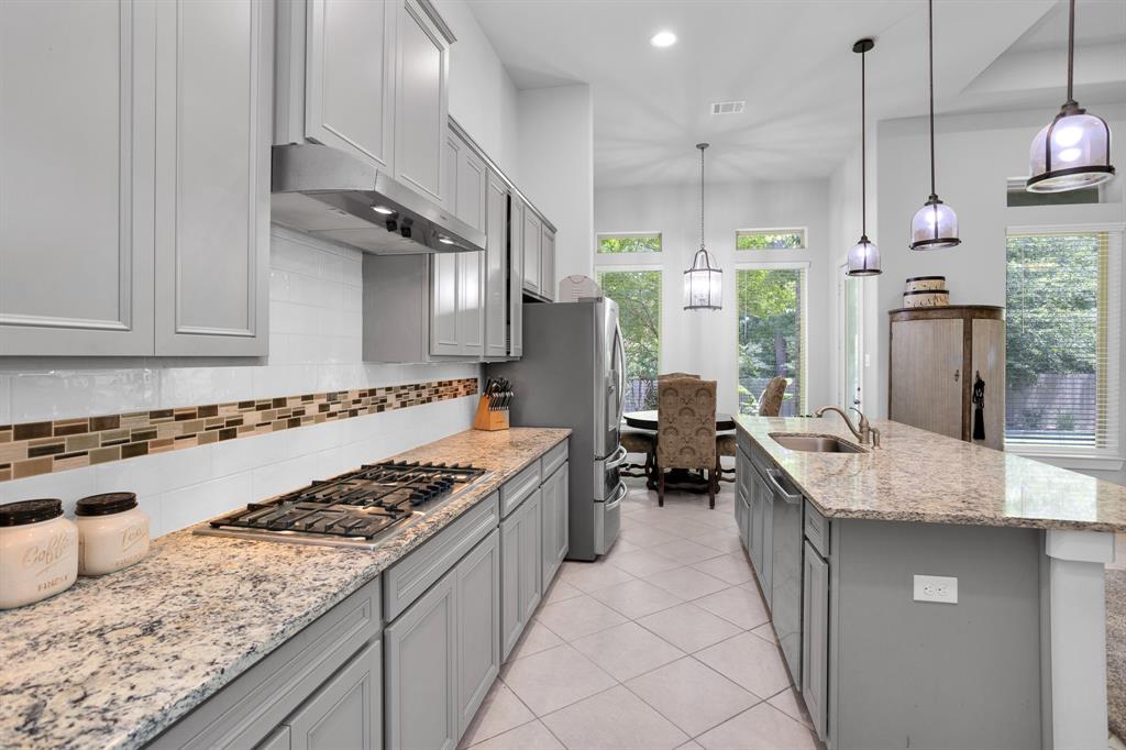 Huge Island Kitchen with Bosch Appliances, Butlers Pantry, Walk-in Pantry, Granite Surfaces and Tile Backsplash.