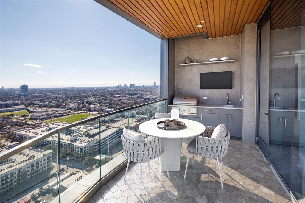 Savor the captivating downtown view from the balcony with a summer kitchen. Enjoy alfresco dining and entertaining with an outdoor kitchen while soaking in the mesmerizing cityscape that surrounds you.