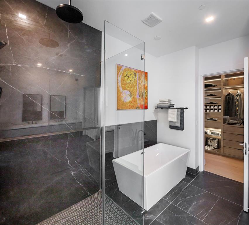 Primary retreat features separate shower, soaking tub and private water closet.