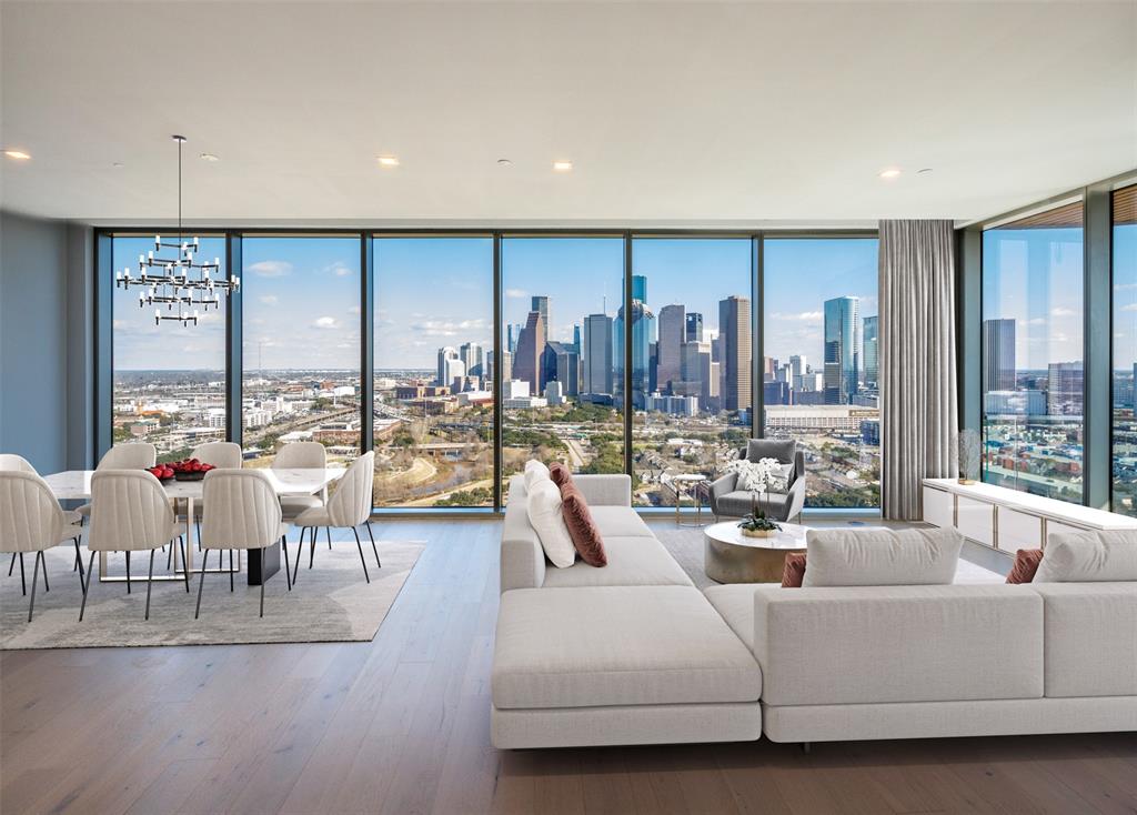 Indulge in the breathtaking cityscape from the Downtown view living room. Floor-to-ceiling windows frame the urban panorama, inviting natural light to illuminate the elegant space. Immerse yourself in the vibrant energy of the city, while relishing the comfort and luxury of this captivating living room retreat.