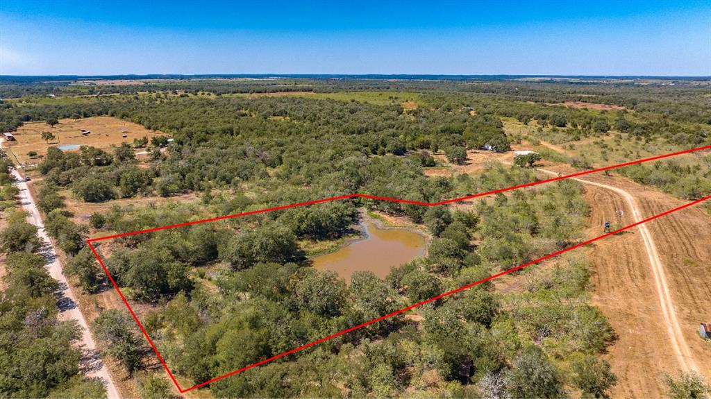 Unrestricted 10.1 ac tract between Katy and San Antonio. Large pond towards front. Seller will order survey, fence and install new entry gate on CR 430. Cut has been made in fence on CR 430 for access. No minerals convey. Part of larger tract
