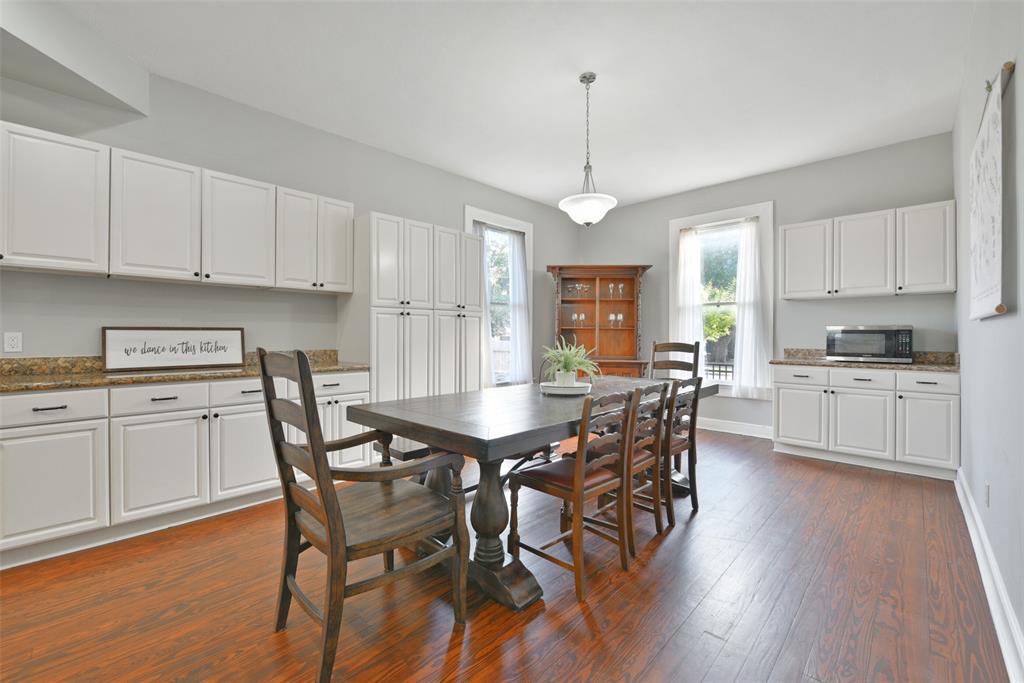 Fine finishes in the kitchen and dining area include updated white cabinetry topped with sleek granite countertops. Several windows allow an abundance of natural sunlight into the space.