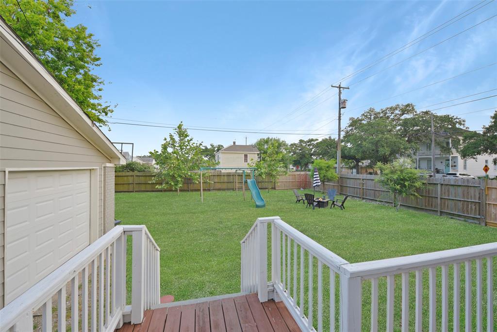 A full panel glass door in the eat-in dining space in the kitchen opens onto this raised back deck overlooking a HUGE fenced backyard with plenty of space for a pool, playset, or whatever your heart dreams of!