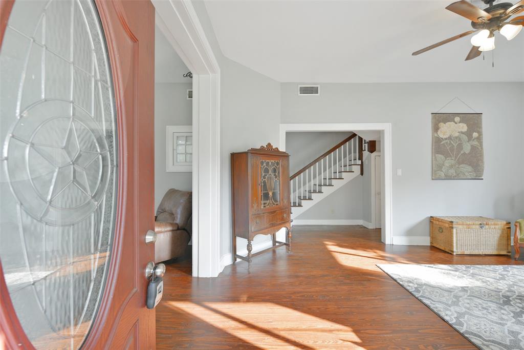 Four steps lead up to the covered front porch to a front door with an oval leaded glass insert. Inside, sunlight streams through numerous windows to splash light throughout the family room and adjoining study.