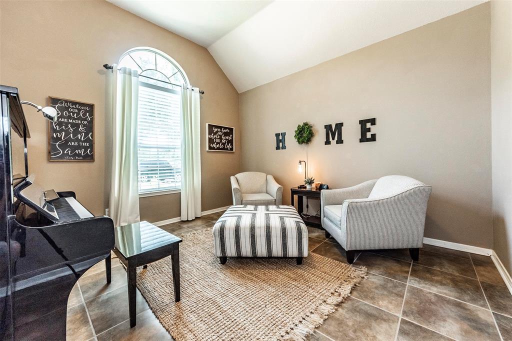 Home-office/study area or additional living room with vaulted ceilings and great natural lighting.
