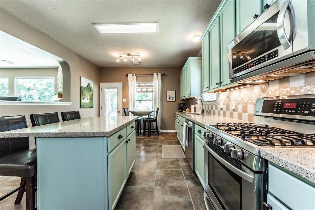Extensive lighting in the kitchen and breakfast area with designer tile backsplash and gorgeous Quartz countertops.