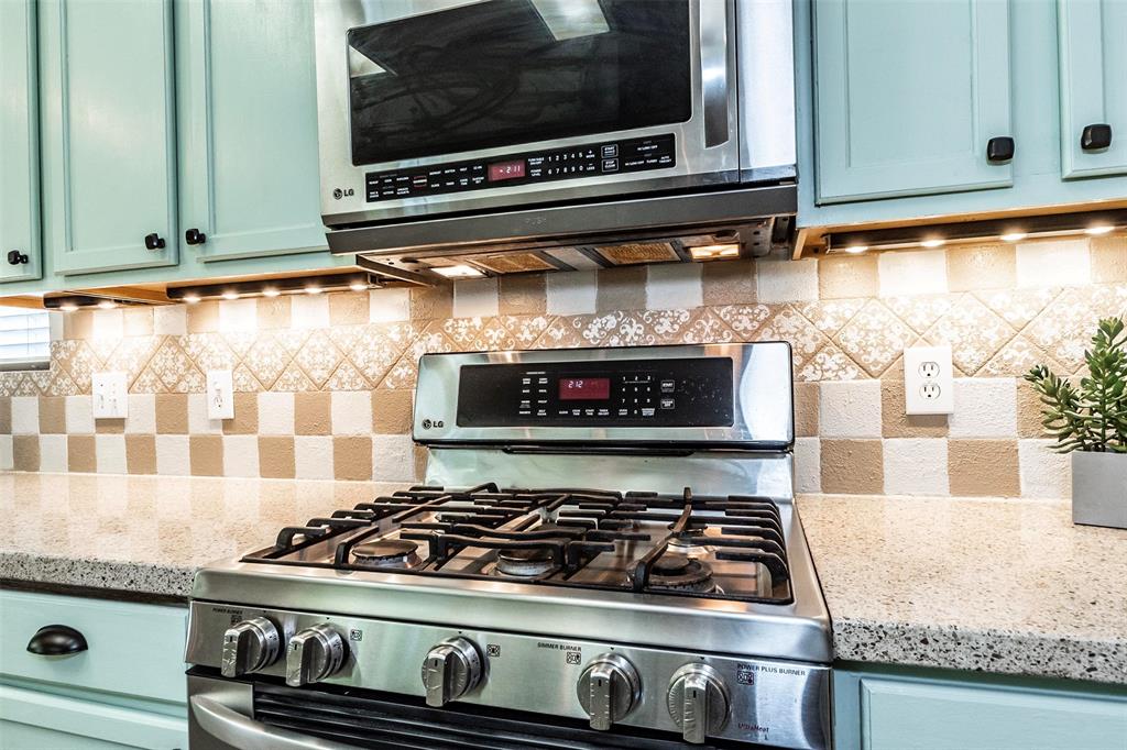 Updated LG stainless steel 5-burner gas range with built-in overhead microwave.