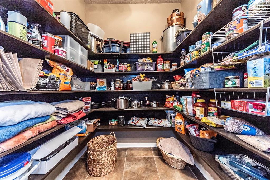 Check out this enormous walk-in pantry with storage shelves,