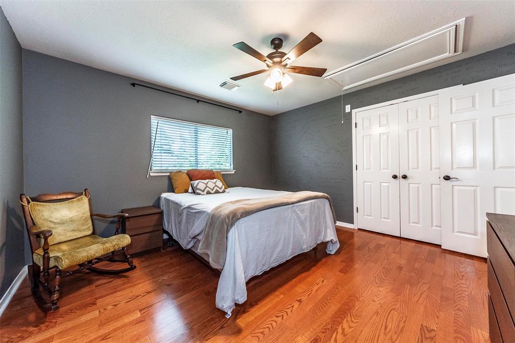 Another spare bedroom on the 2nd level with updated antique bronze hardware, wood flooring, ceiling fan and large closet space. Additional attic storage with 50-gallon water heater.