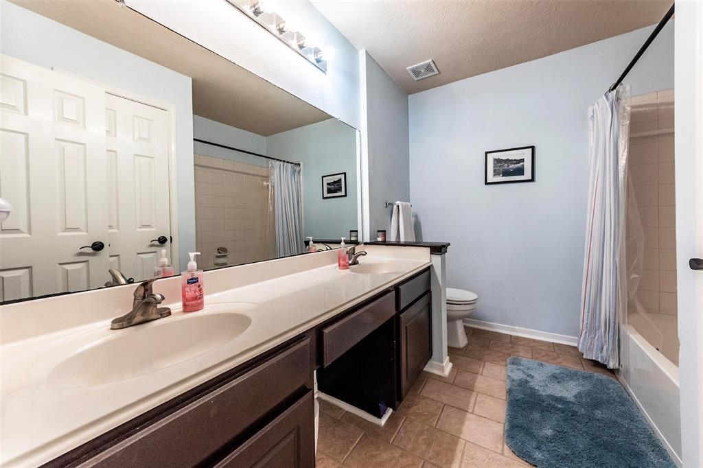 Secondary full sized bath on the 2nd level with linen storage closet, double-sinks, vanity area, updated antique bronze hardware, tile flooring, and shower/tub combination.
