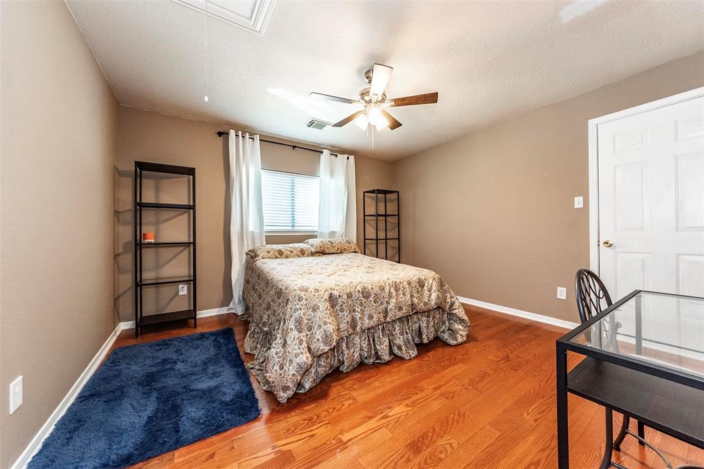4th bedroom is very spacious with wood flooring and large closet space. Check out the bonus walk-in, decked attic space with lighting for storage.