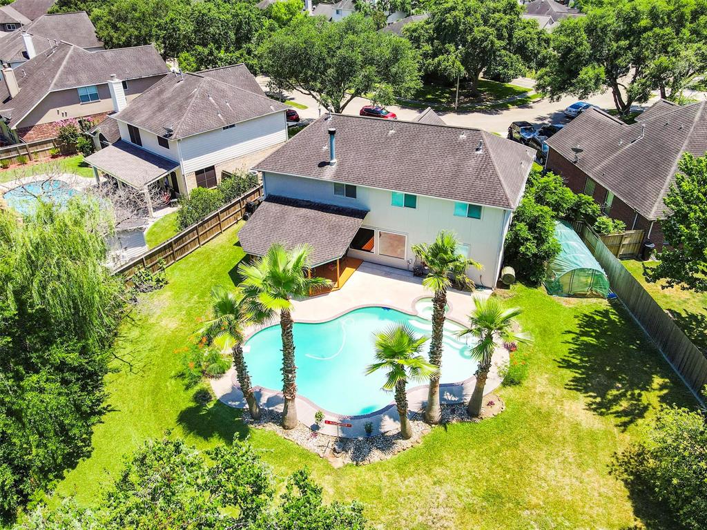 Your Own Peace of Paradise! Aerial view of the spacious backyard with big beautiful pool & back covered patio.