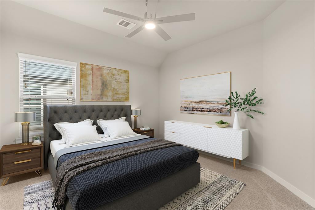 Secondary bedroom features plush carpet, custom paint, ceiling fan with lighting, large window with privacy blinds and access to the Jack and Jill bath.