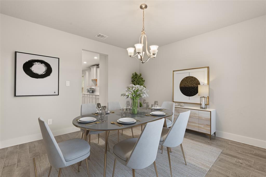 Make memories gathered around the table with your family and friends! This dining room features high ceilings, custom paint, gorgeous flooring and chandelier.