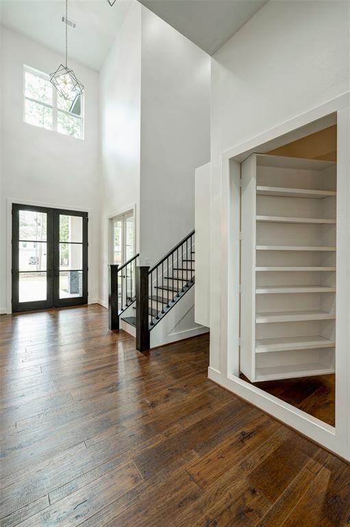 Located off the foyer, this hidden room is perfect for holiday storage without having to go upstairs! A second hidden room is located next to the back staircase and houses AV for the home.