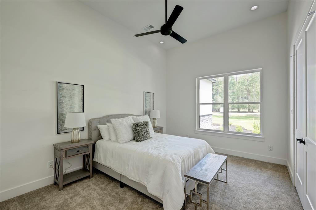 Located on the first floor, this secondary bedroom has an attached bath and walk-in closet.