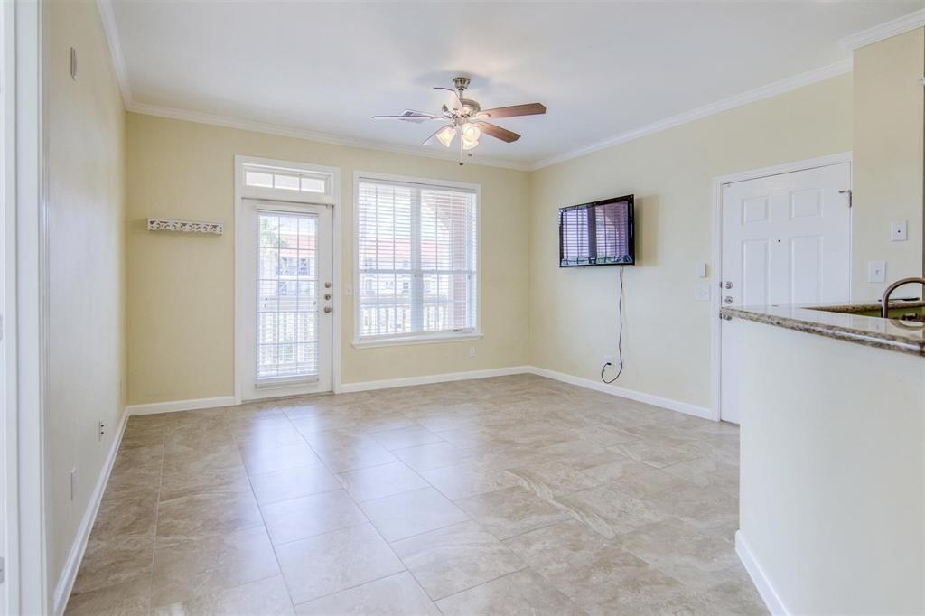 The living room provides access to the patio. Television is included with the sale.