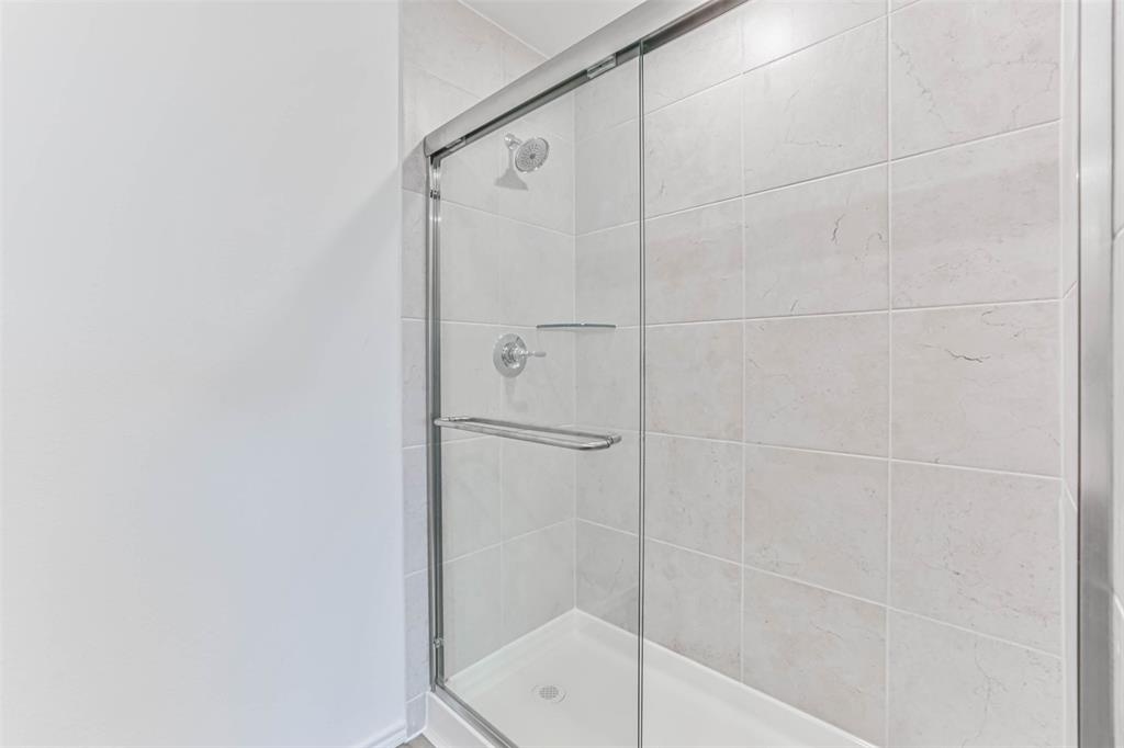 Walk in shower with fiberglass doors.