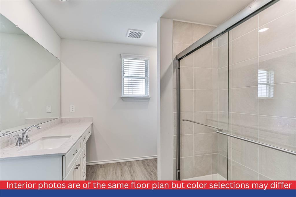 Connected to the master bedroom is a spacious en-suite bathroom, complete with a luxurious walk-in shower.