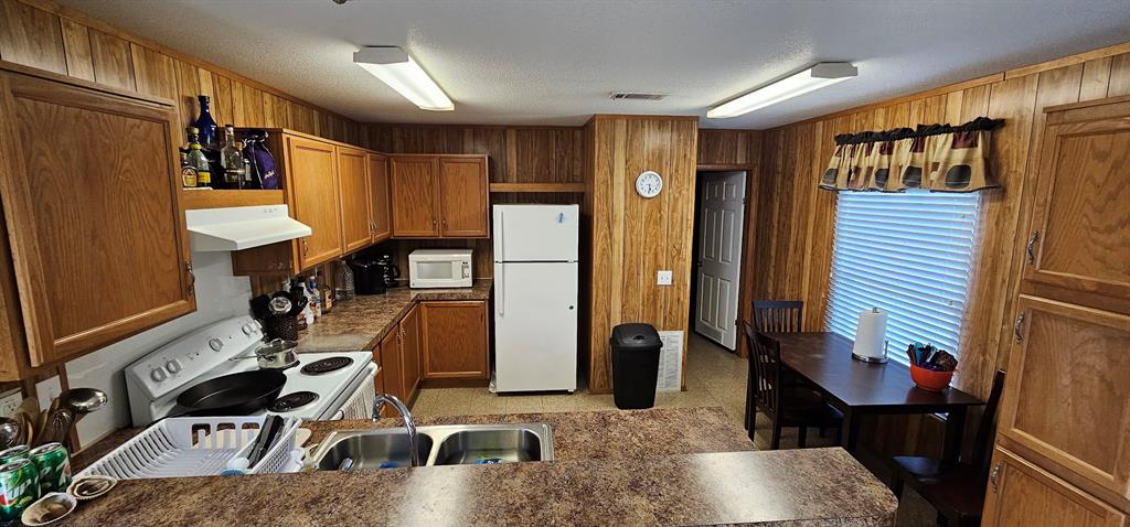 Full kitchen in this home, with dishwasher, refrigerator, oven/stove top, and microwave - all included.