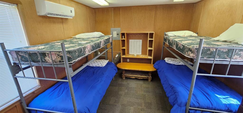 4 twin-size bunk beds in this bedroom with simple shelving for your necessities.