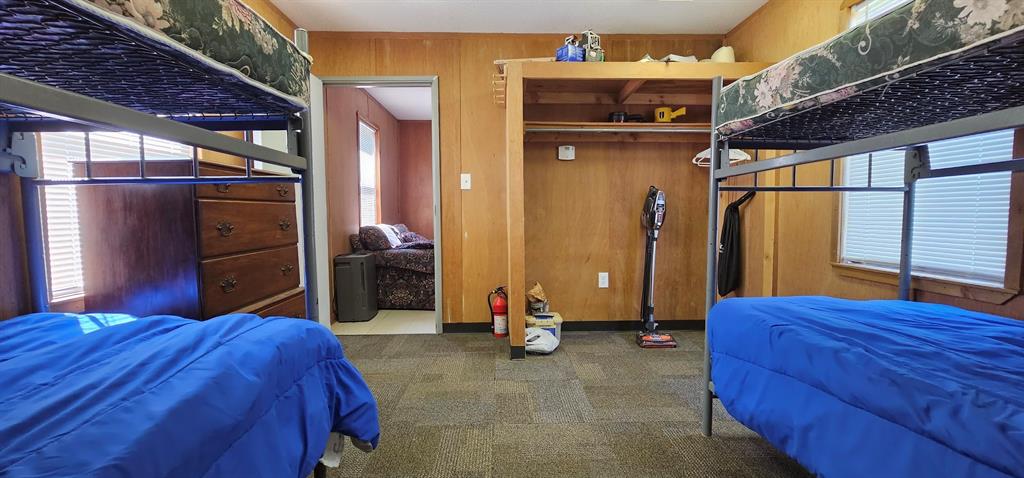 This room has an open closet space to hang clothes. Just add a curtain or some doors.