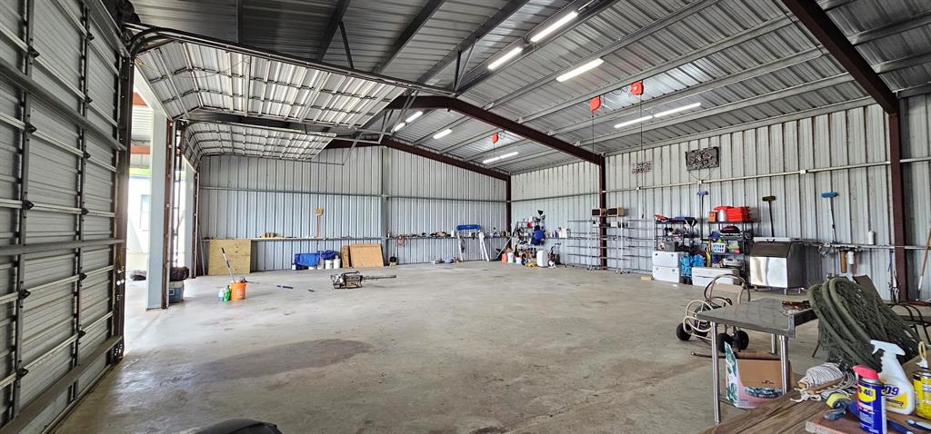 Barn will hold 3 boats. Each bay has it\'s own roll up/down door and retractable electrical cord on the ceiling. This could be built out and made into another living quarters or partial living with garage space. Endless ideas here!