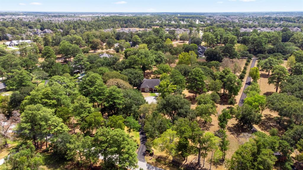 This beautiful estate sits nestled in 4 park like acres.