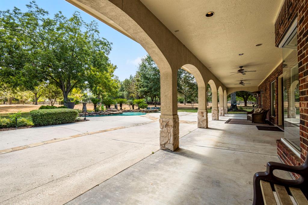 This is the view coming from the garage. The long covered archway walk is perfect for hanging out out of the sun, while the large veranda is ideal for outdoor social gatherings, celebrations, parties, or anything your imagination can come up with.