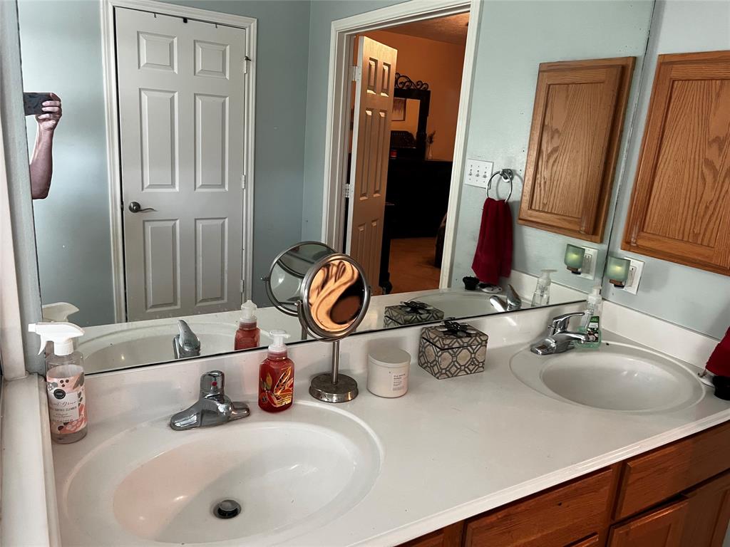Double sinks in the primary bathroom with a walk in closet.