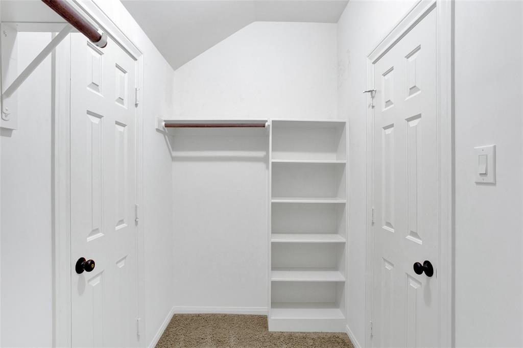 Primary bedroom closet with shelves