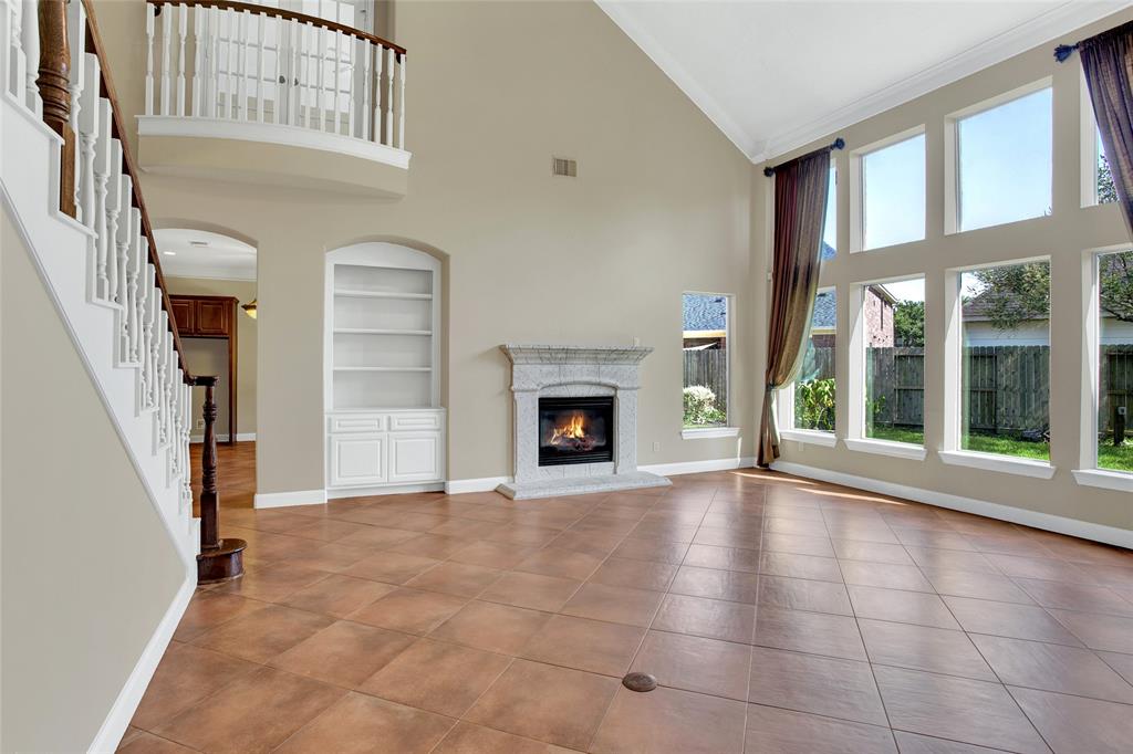Indulge in the warmth of the fireplace in the spacious living room