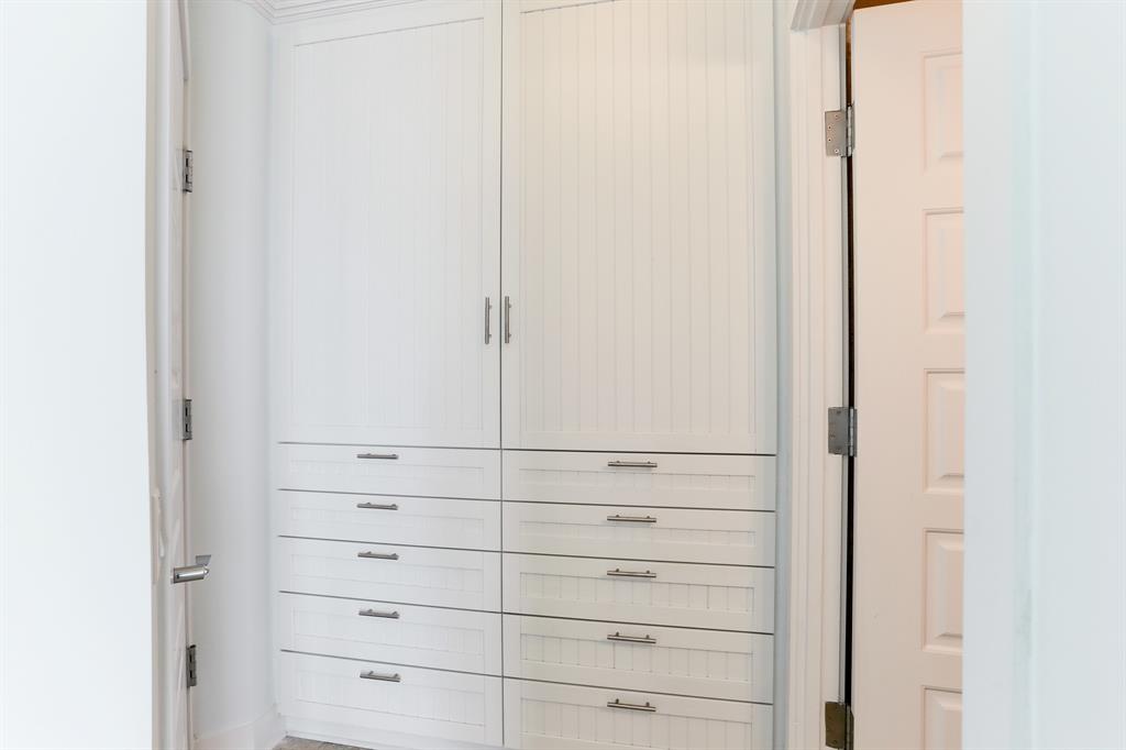 In the secondary bedroom area, you\'ll find a set of handsome built-ins thoughtfully designed to accommodate and organize your personal belongings.