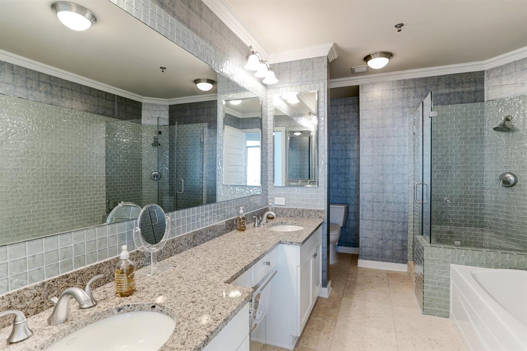 The Primary Bath, which features dual sinks and luxurious granite countertops, is very spacious.