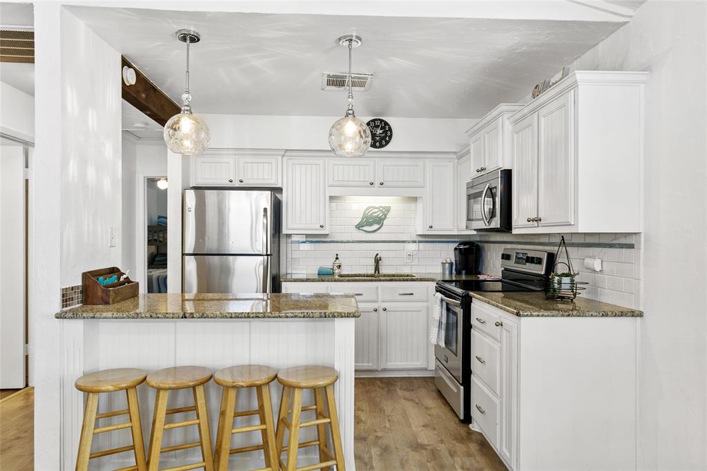 Updated kitchen with stainless appliances and granite countertops.