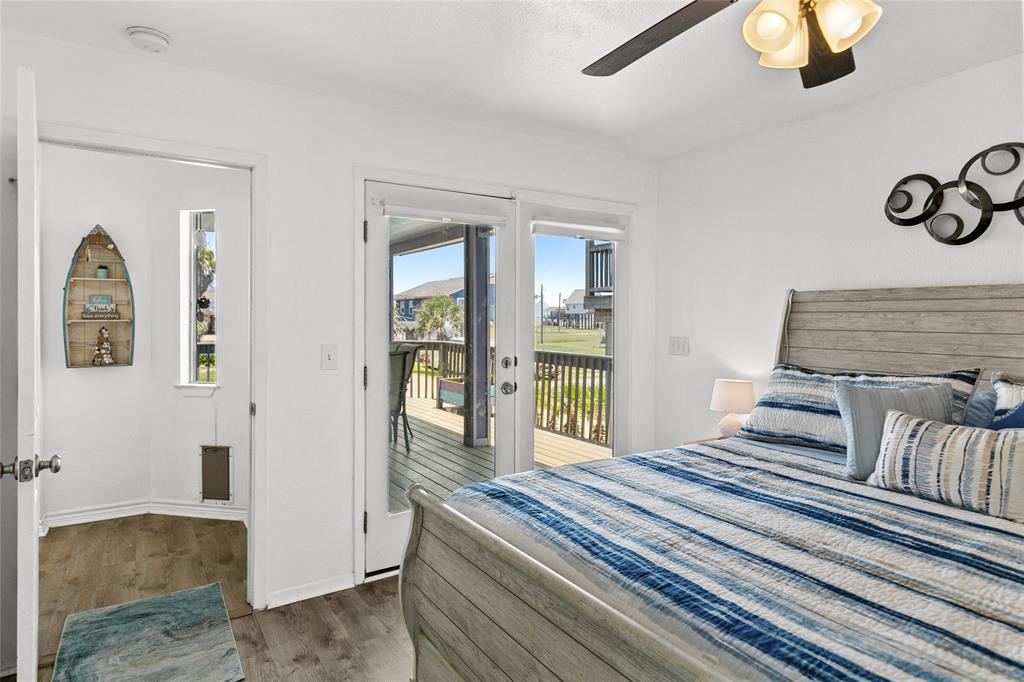 Primary bedroom with private bathroom and large double doors leading onto the deck.