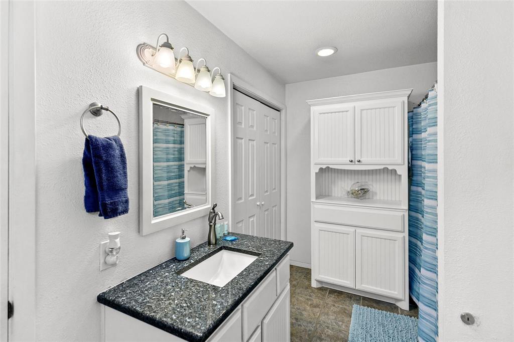 Primary bathroom with tub/shower combo, closet, owners closet, and washer/dryer.