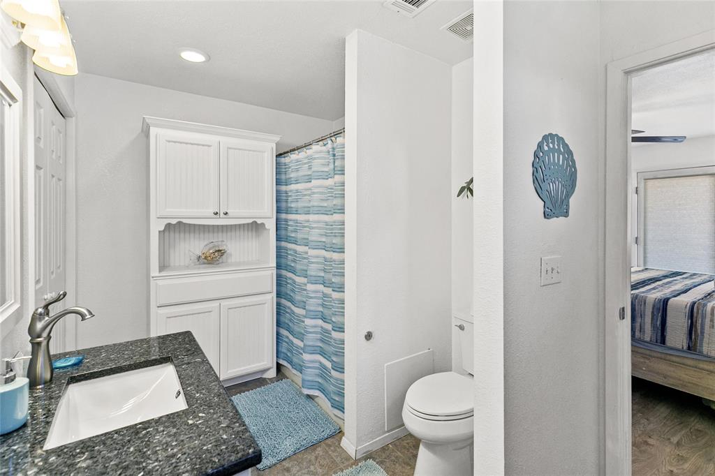 Primary bathroom with tub/shower combo, closet, owners closet, and washer/dryer.