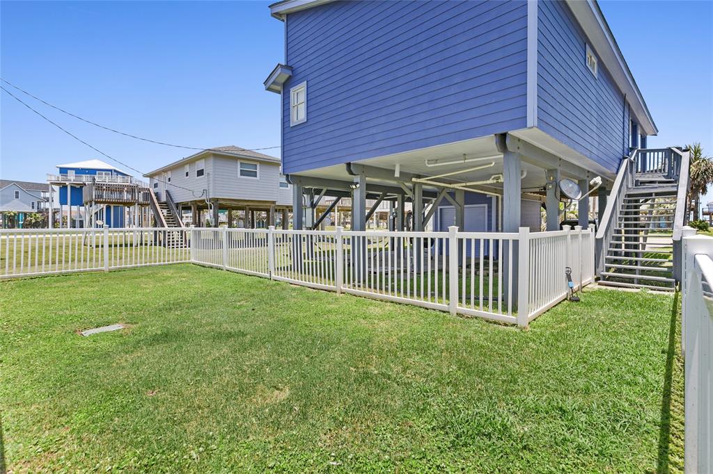 Fenced in area in backyard with stair access.