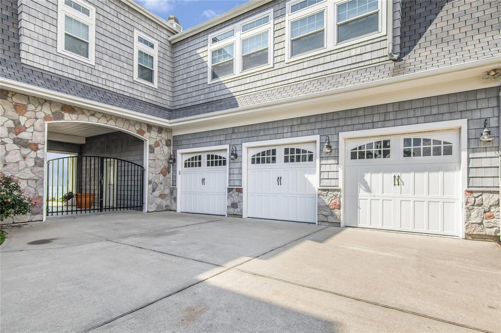 Three car garage, with large storage room above.