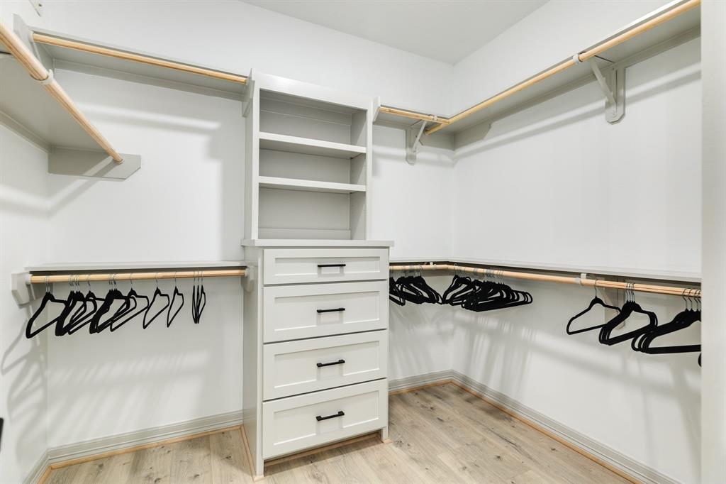 The primary bedroom has a large walk-in closet with built ins