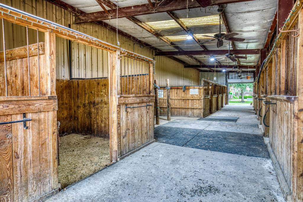 Barn 1, closest to house. Also has 3 bed, 2 bath, 2 level apartment. Entrance/exit to left of tie station. 14 horse stalls, 8 fans, storage & tack room, art/office room w/half bath.