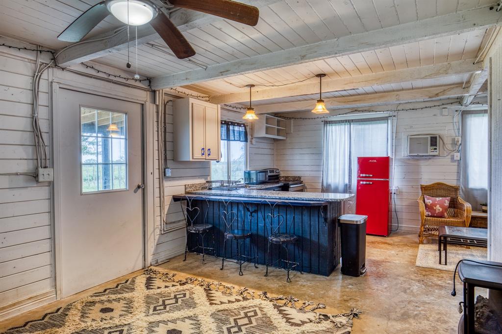 Efficiency apartment in Lonestar Barn (Barn #2). Offers Living/Bed combo, full kitchen w/breakfast bar, dining area, closet & full bath. Wall unit for cooling. Covered deck. Fenced yard.