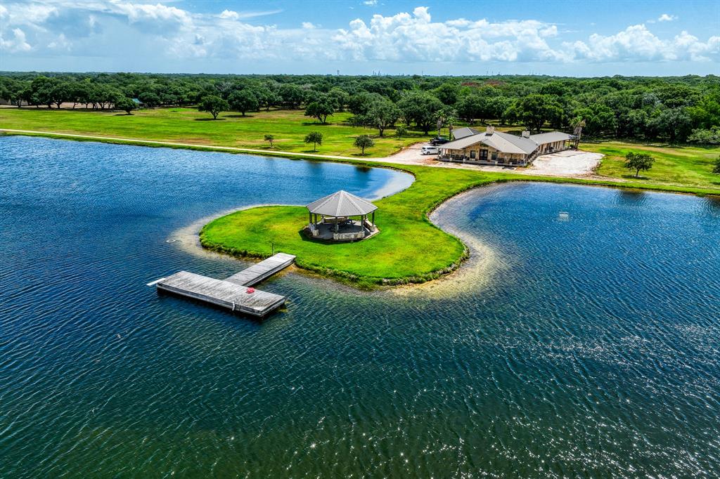 Rio Viejo Ranch, 900+/- acs in Matagorda County offers a myriad of possibilities for recreational and agricultural pursuits. At the heart of the ranch, you'll find an exquisite lodge with two bedroom wings featuring 8 private bedrooms. The lodge offers a media room, 4-sided fireplace, spacious kitchen, game area/bar. 50'x50' shop with apartment & 20' overhang.  Horse barn. The picturesque clear lake with gazebo in front of the lodge is filled with bass and has dedicated well.. 3 distinct eco systems begin with Tifton 85 grass pastures moving into glorious oak coverage, pecan groves and approx 400 acres of high fence fronting the Colorado River. Abundant wildlife includes deer, alligator, hogs, ducks and more.  2 Ducks Unlimited ponds create a haven for various waterfowl. Hay production, grazing, cattle pens and ponds. Recreation, hunting, working ranch, private retreat, this expansive property offers an exceptional opportunity to make your dreams a reality.