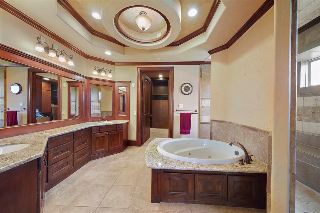 Owners bath offers luxurius jetted spa and abundant vanity and sink counter area