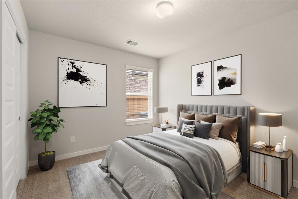 Secondary bedroom features plush carpet, custom paint and a large window with privacy blinds.