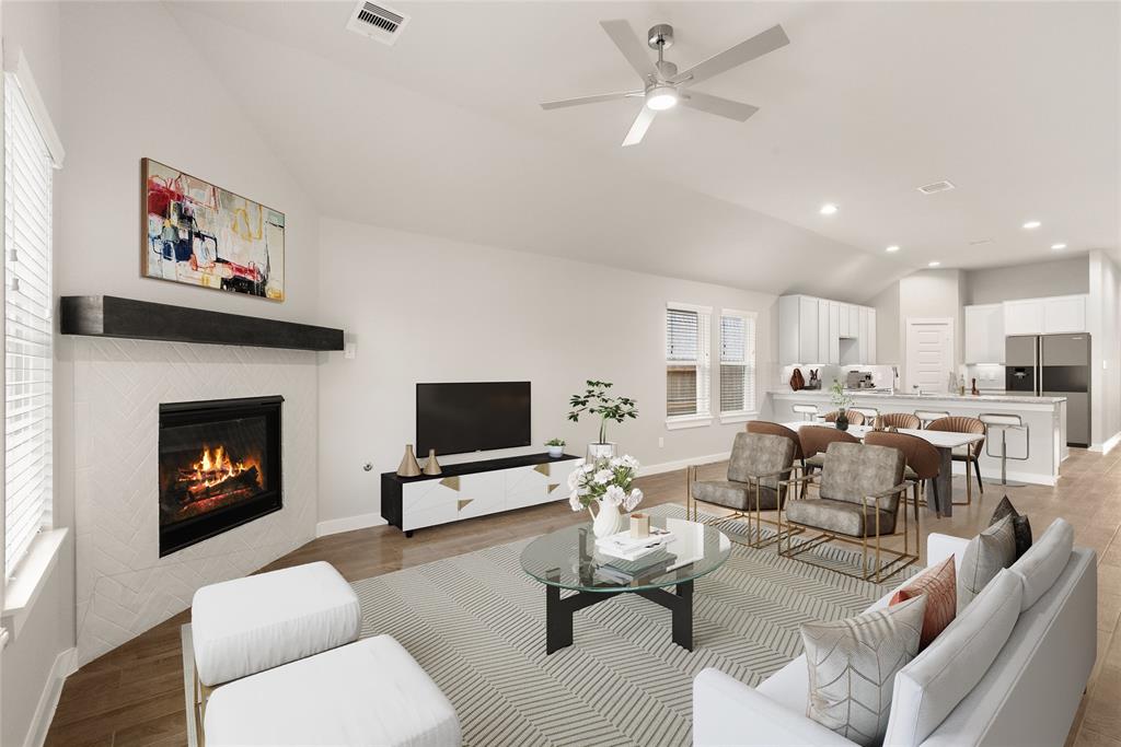 Gather the family and guests together in your lovely living room! Featuring high ceilings, recessed lighting, ceiling fan, custom paint, gorgeous floors, fireplace with mantel and large windows that provide plenty of natural lighting throughout the day.