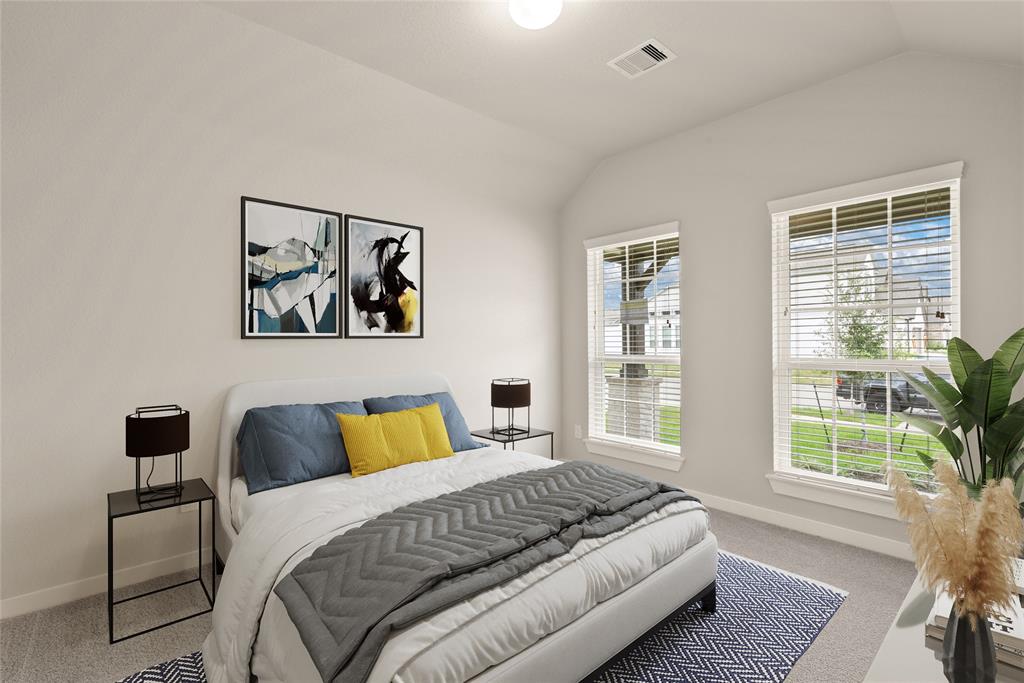 Secondary bedroom features plush carpet, custom paint, large windows with privacy blinds and access a private bath.