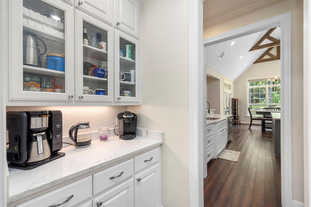 Enjoy the convenience of a butler pantry that opens right into the kitchen, conveniently transforming it into an ideal space for setting up a cozy coffee bar.